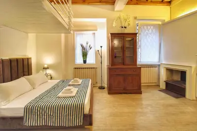 a bedroom with a bed and a fireplace at Cozy Studio Flat in Trastevere by Yourhost in Rome