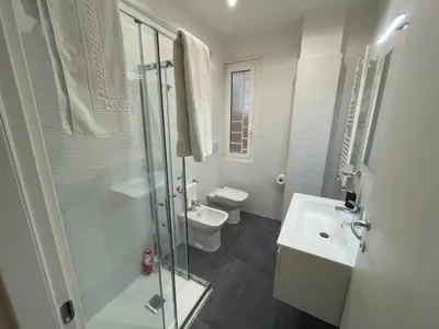 a bathroom with a toilet and a sink and a shower at Home Vatican Oasis in Rome