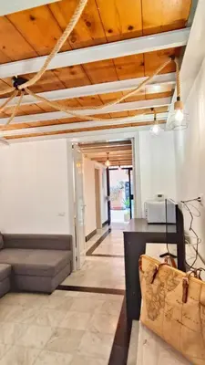 a living room with a couch and a wooden ceiling at Sanniti' Home in Rome