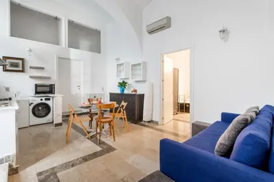 a living room with a blue couch and a table at Sanniti' Home in Rome