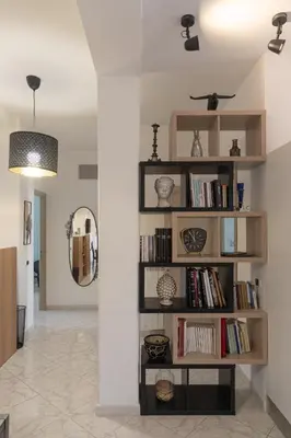 a room with a book shelf with books at Vatican Walls Apartment in Rome