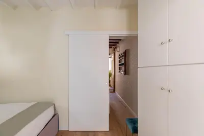 a bedroom with white cabinets and a bed at iFlat The Heart of Monti in Rome