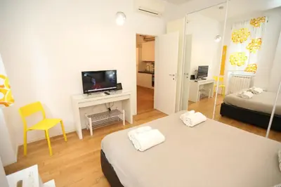 a hotel room with two beds and a television at New Apartment Vatican Museum in Rome