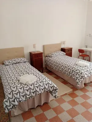 two beds sitting next to each other in a room at Breakfast at St Peter in Rome