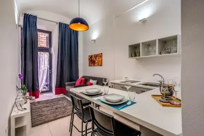a kitchen and living room with a table and chairs at Studio Artis Piazza di Spagna in Rome