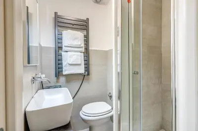 a bathroom with a toilet and a sink and a shower at Studio Artis Piazza di Spagna in Rome