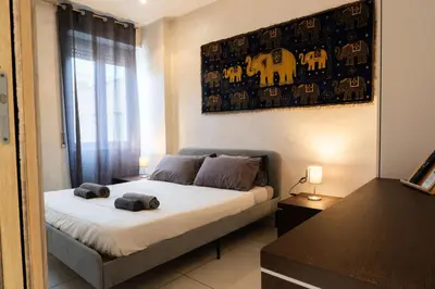 a bedroom with a bed with two towels on it at Cipro Roomy House - Vatican in Rome