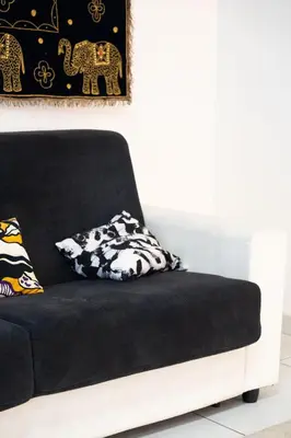 a black and white couch with a pillow on it at Cipro Roomy House - Vatican in Rome