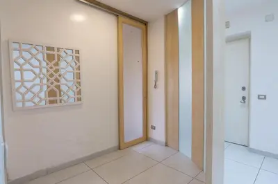 a hallway with a door and a window at Cipro Roomy House - Vatican in Rome