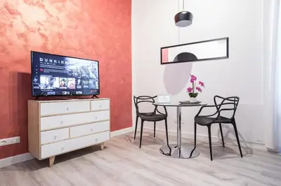 a dining room with a table and chairs and a tv at Cozy Studio Campo dè Fiori in Rome