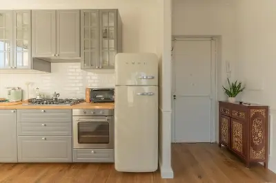 a kitchen with a white refrigerator in a kitchen at Aventino Terrace in Rome