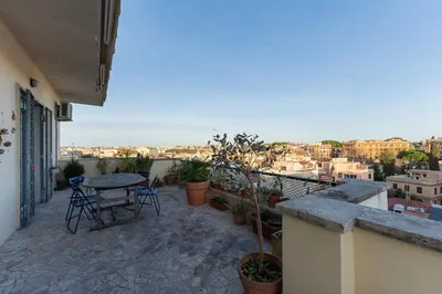 a patio with a table and chairs on a balcony at Aventino Terrace in Rome