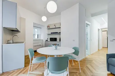 a kitchen and dining room with a white table and chairs at Apt in the heart of the city in Rome