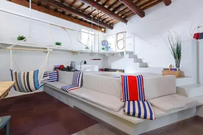 a living room with a couch and stairs at Pantheon Loft - B in Rome
