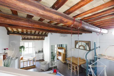 a living room with wooden ceilings and a table at Pantheon Loft - B in Rome