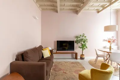 a living room with a couch and a tv and a table at iFlat The Monti Experience in Rome