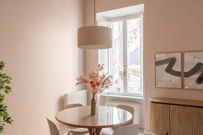 a dining room with a table and chairs and a window at iFlat The Monti Experience in Rome