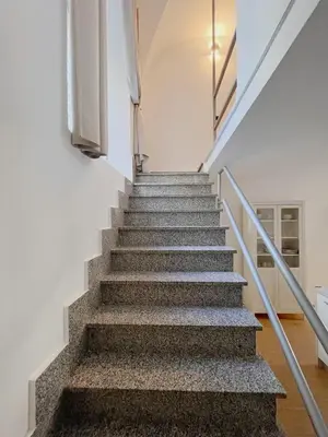 a staircase in a white building with a stair case at Life is Roma Termini in Rome