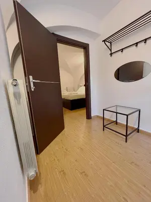a room with a door and a table and a bed at Life is Roma Termini in Rome