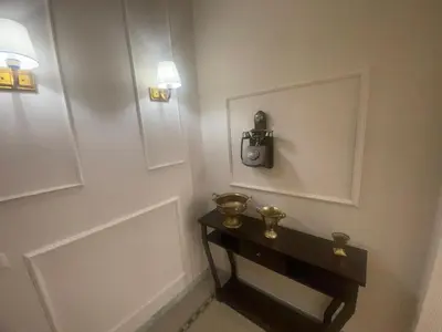 a room with a table with a clock on the wall at Glint House Roma Sapienza in Rome