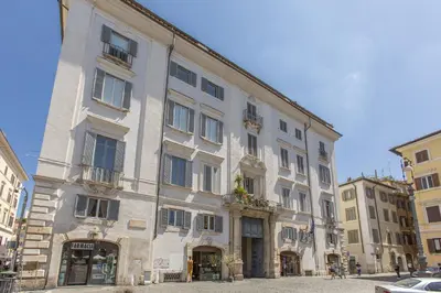 a large white building on a city street at Farnese House in Rome
