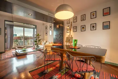 a living room with a table and chairs at Tiffany's apartment Flaminio in Rome