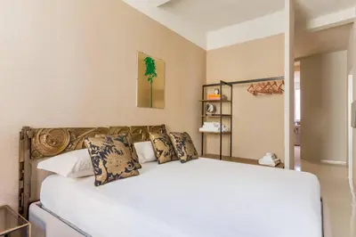 a bedroom with a large white bed with pillows at My Trastevere Suite in Rome