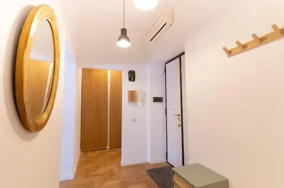 a hallway with a mirror and a door at Scipioni Holiday House in Rome