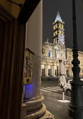 a building with a clock tower at night at Dielle Apartments ROMA in Rome