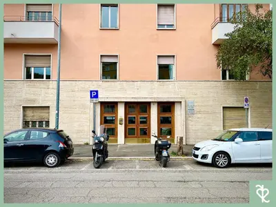 two motorcycles parked in a parking lot in front of a building at RomeSweetRome in Rome