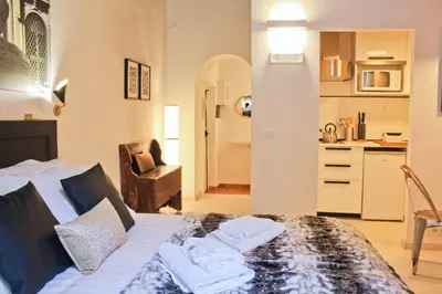 a bedroom with a bed with towels on it at Sophisticated Studio Decor in Rome