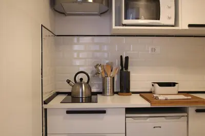 a kitchen counter with a tea kettle on a stove at Sophisticated Studio Decor in Rome