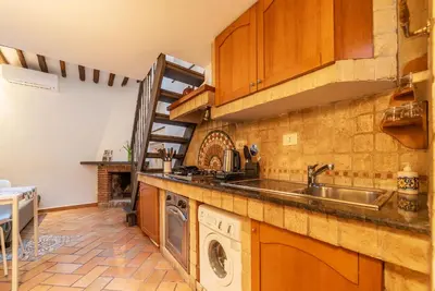 a kitchen with a sink and a washing machine at Trastevere Escape - Charme Holidays in Rome