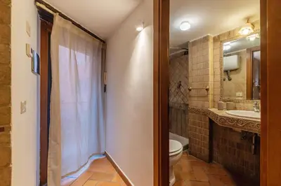 a bathroom with a toilet and a sink at Trastevere Escape - Charme Holidays in Rome