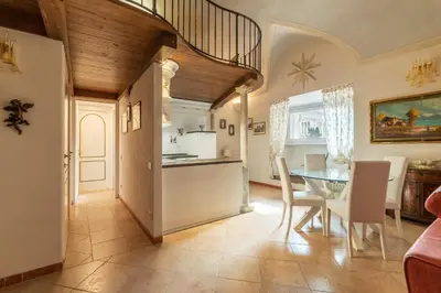a kitchen and dining room with a table and chairs at GuestHost - Palazzo Altieri Elegant Apartment in Rome