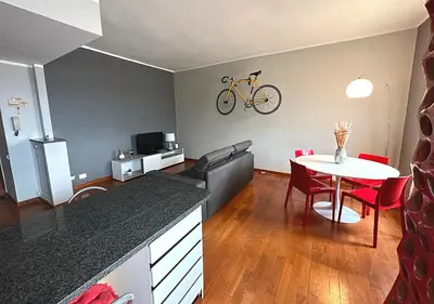 a living room with a table and a bike on the wall at Window in the sky by Palazzo Senesi in Rome