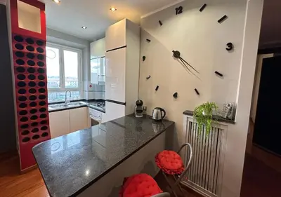 a kitchen with a large clock on the wall at Window in the sky by Palazzo Senesi in Rome