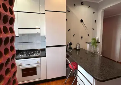 a kitchen with white cabinets and a stove top oven at Window in the sky by Palazzo Senesi in Rome