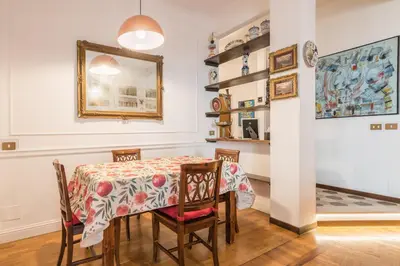 a dining room with a table and chairs at Charming Mazzini Apartment in Rome
