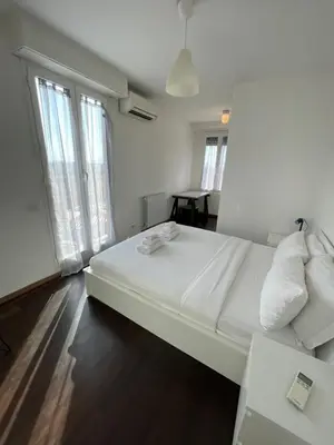 a large white bed in a room with windows at Terrace on the 11th floor in Rome