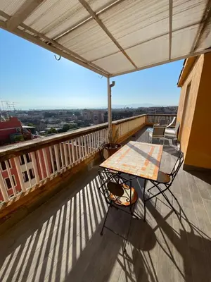a table and chairs on the balcony of a building at Terrace on the 11th floor in Rome
