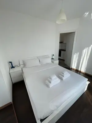 a white bed in a room with two towels at Terrace on the 11th floor in Rome