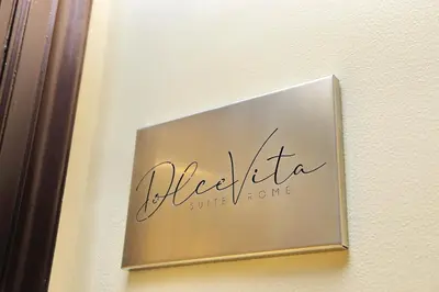 a sign for a hotel on a wall at DolceVitaSuite in Rome