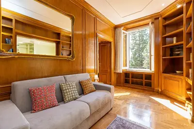 a living room with a couch and a mirror at Ludovisi by Rental in Rome in Rome