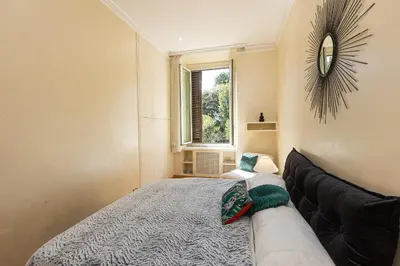 a bedroom with a bed and a couch and a window at Ludovisi by Rental in Rome in Rome