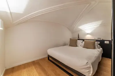 a bed in a room with a white ceiling at Toscana 1 - FromHometoRome in Rome