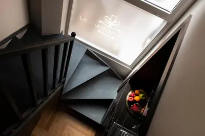 a bowl of fruit in a bowl on the stairs at Piazza di Spagna 66 Luxury Apartment - Maison D'Art Collection in Rome