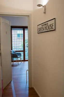 a hallway with a green house sign on a wall at Traversari 27 in Rome
