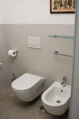a white bathroom with a toilet and a sink at Traversari 27 in Rome