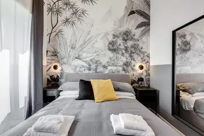 a bedroom with a large bed with a yellow pillow at Classy Apartment - Auditorium & Villa Borghese in Rome